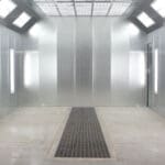 paint line An empty Powder Coating Booth with a tiled floor and a skylight.
